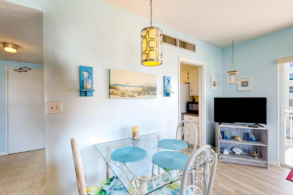a dining room with a glass table and chairs at Turtle Time Suite in Satellite Beach