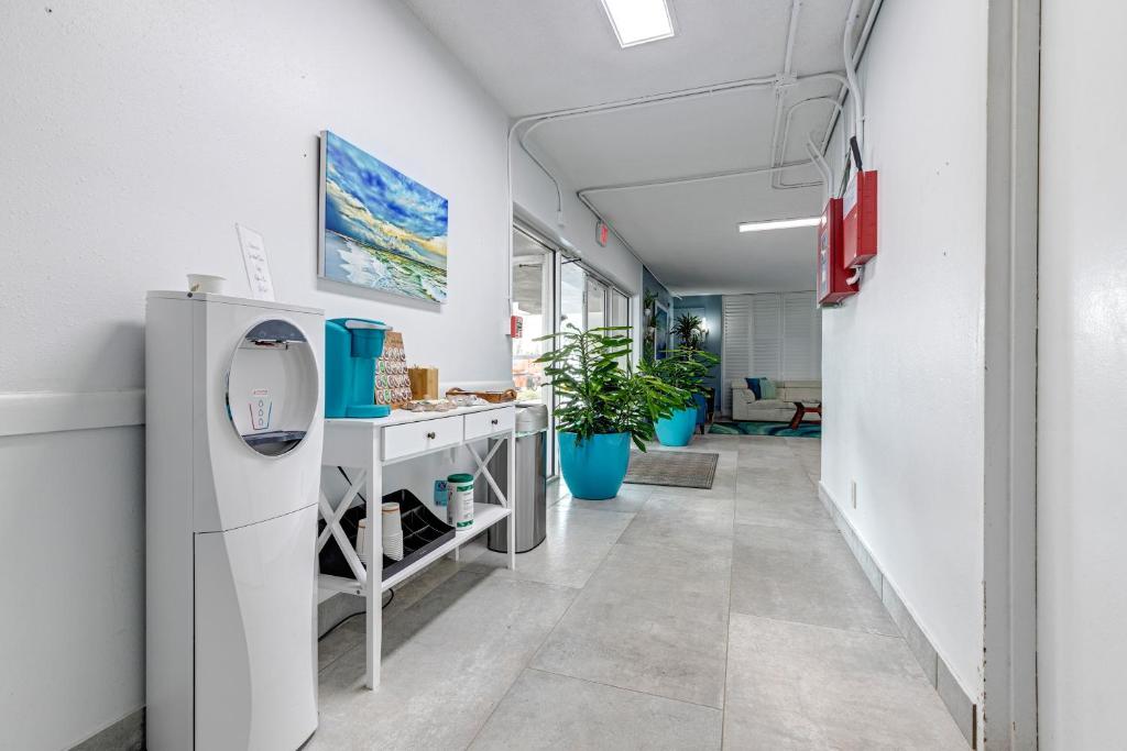 an empty hallway in an office with a refrigerator at Turtle Time Suite in Satellite Beach