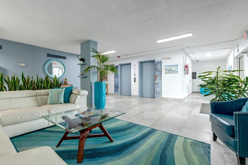 a living room with a white couch and a glass table at Turtle Time Suite in Satellite Beach