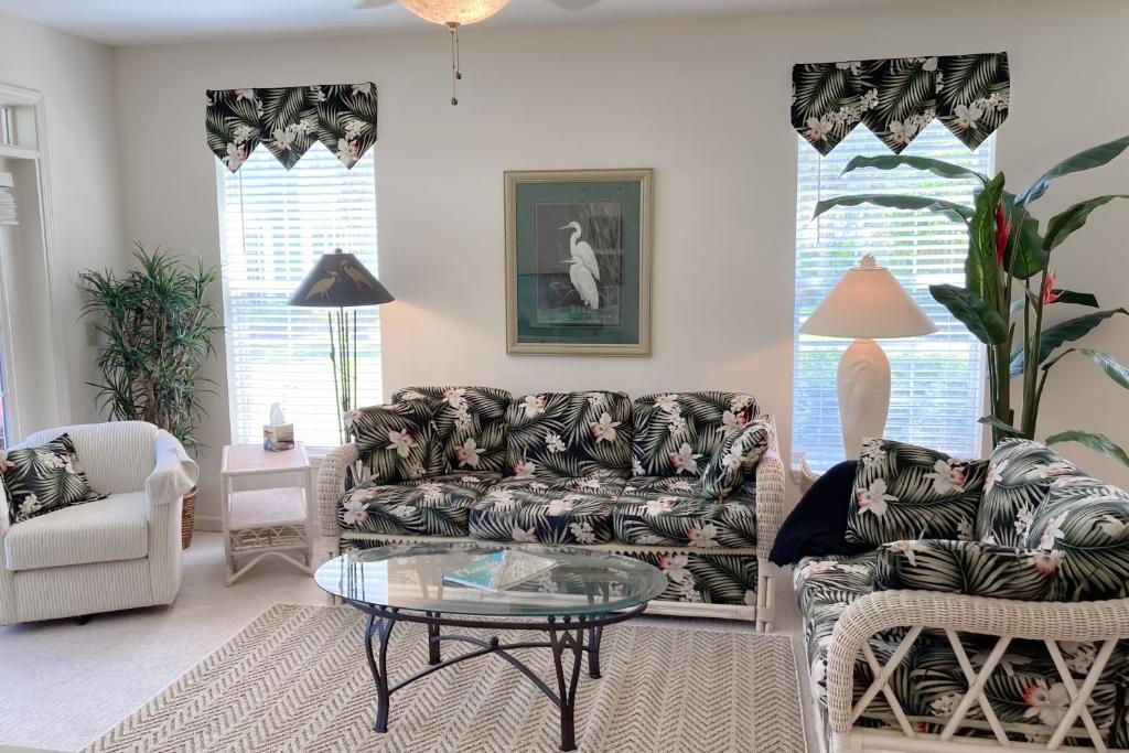 a living room with a couch and chairs and a table at Atlantis Bliss Haven in Saint Augustine Beach