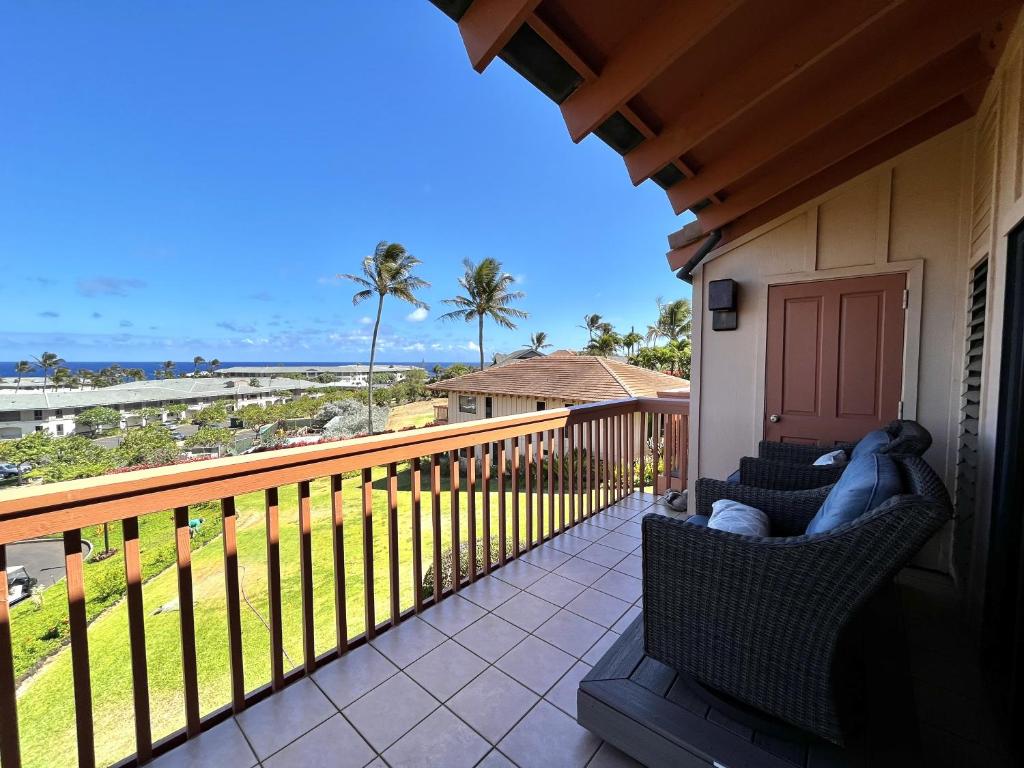 a balcony with chairs and a view of the ocean at Makanui at Poipu Resort 222 in Koloa