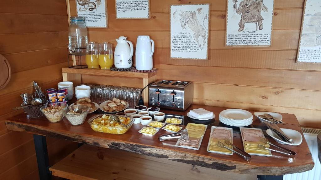 a table with some food on top of it at Hotel y Cabañas Terrazas Vista al Mar hct in Ancud