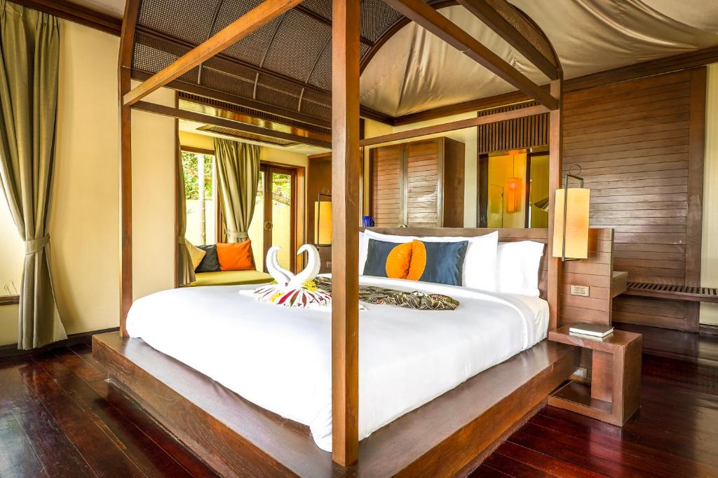a bedroom with a large white bed in a room at Chantaramas Resort in Baan Khai