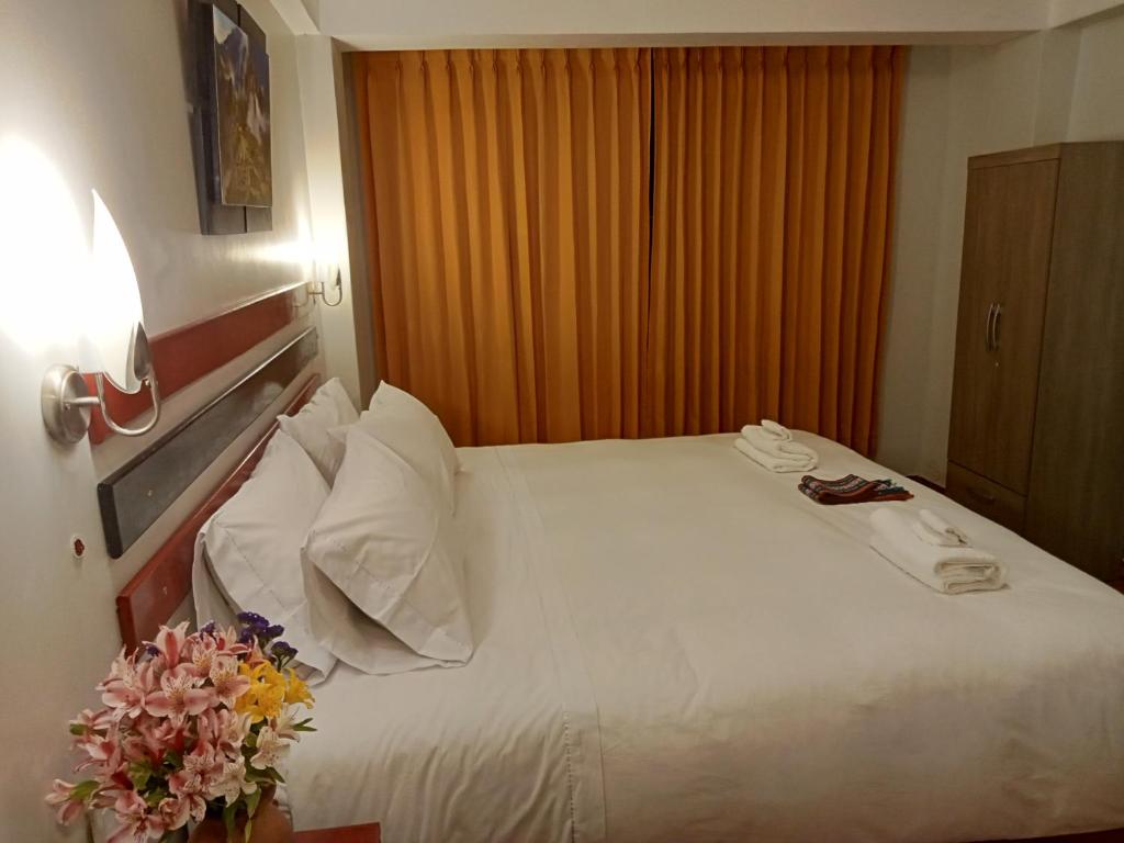 Postel nebo postele na pokoji v ubytování Raymi Inn MachuPicchu