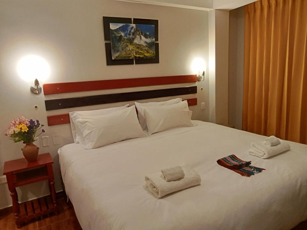 Postel nebo postele na pokoji v ubytování Raymi Inn MachuPicchu