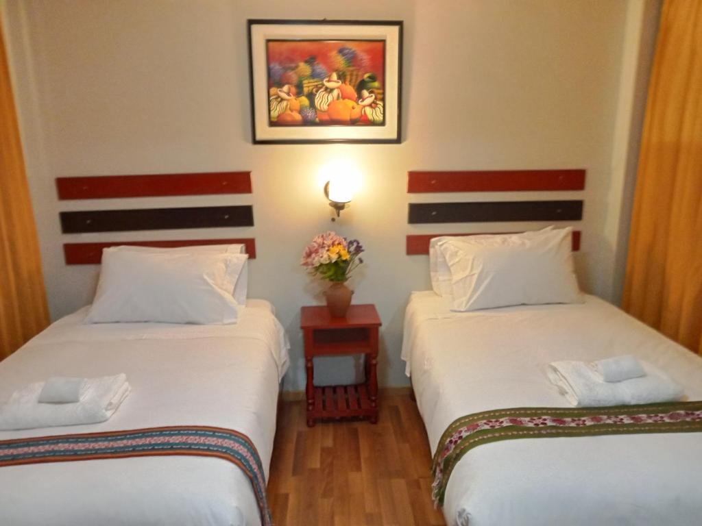 Postel nebo postele na pokoji v ubytování Raymi Inn MachuPicchu