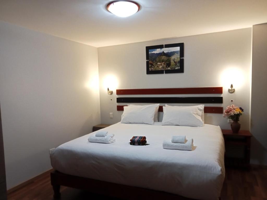 Postel nebo postele na pokoji v ubytování Raymi Inn MachuPicchu