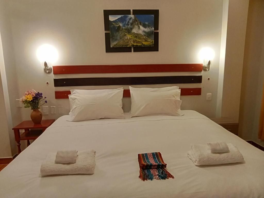 Postel nebo postele na pokoji v ubytování Raymi Inn MachuPicchu