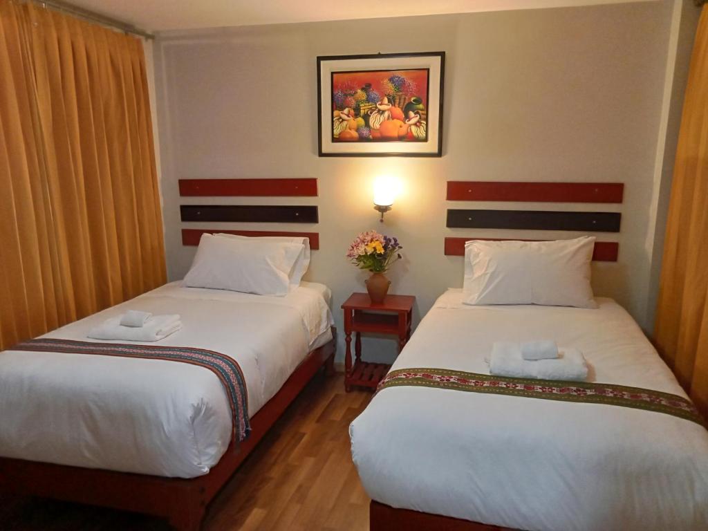 Postel nebo postele na pokoji v ubytování Raymi Inn MachuPicchu