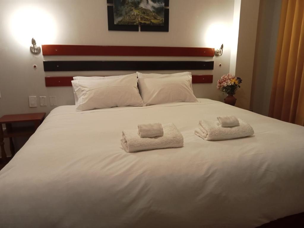 Postel nebo postele na pokoji v ubytování Raymi Inn MachuPicchu