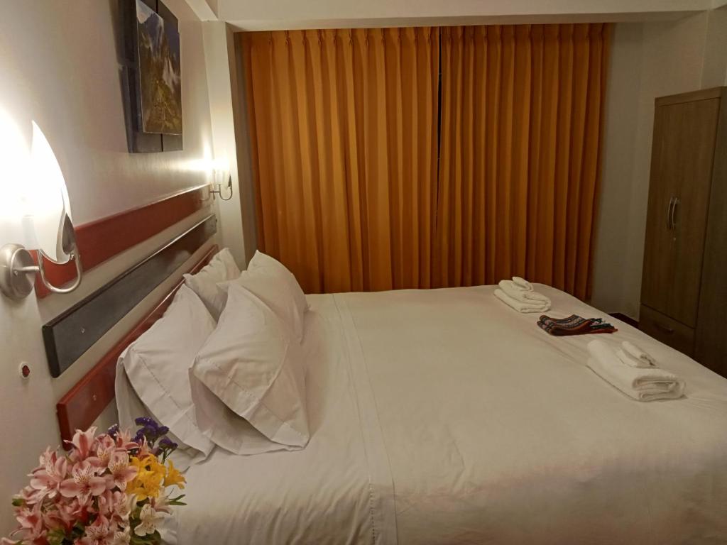 Postel nebo postele na pokoji v ubytování Raymi Inn MachuPicchu