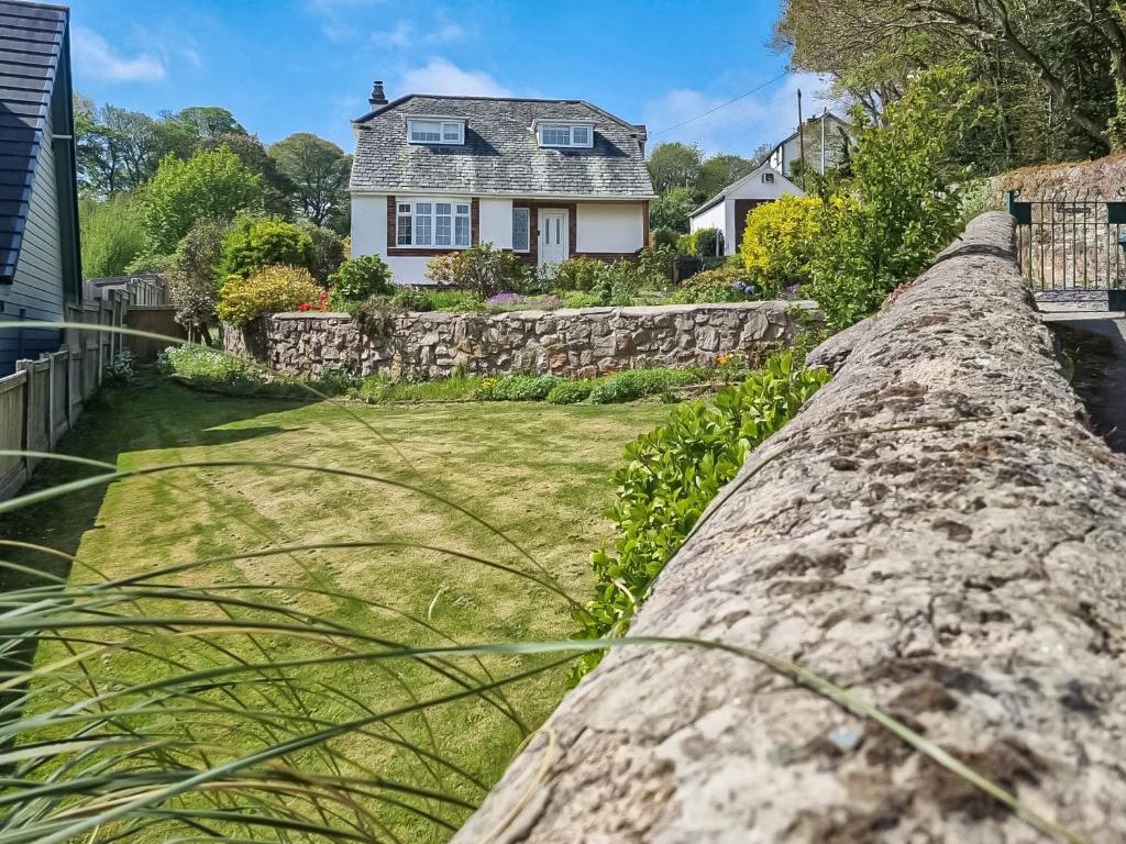 a stone wall in front of a house at Willow Cottage in Conwy