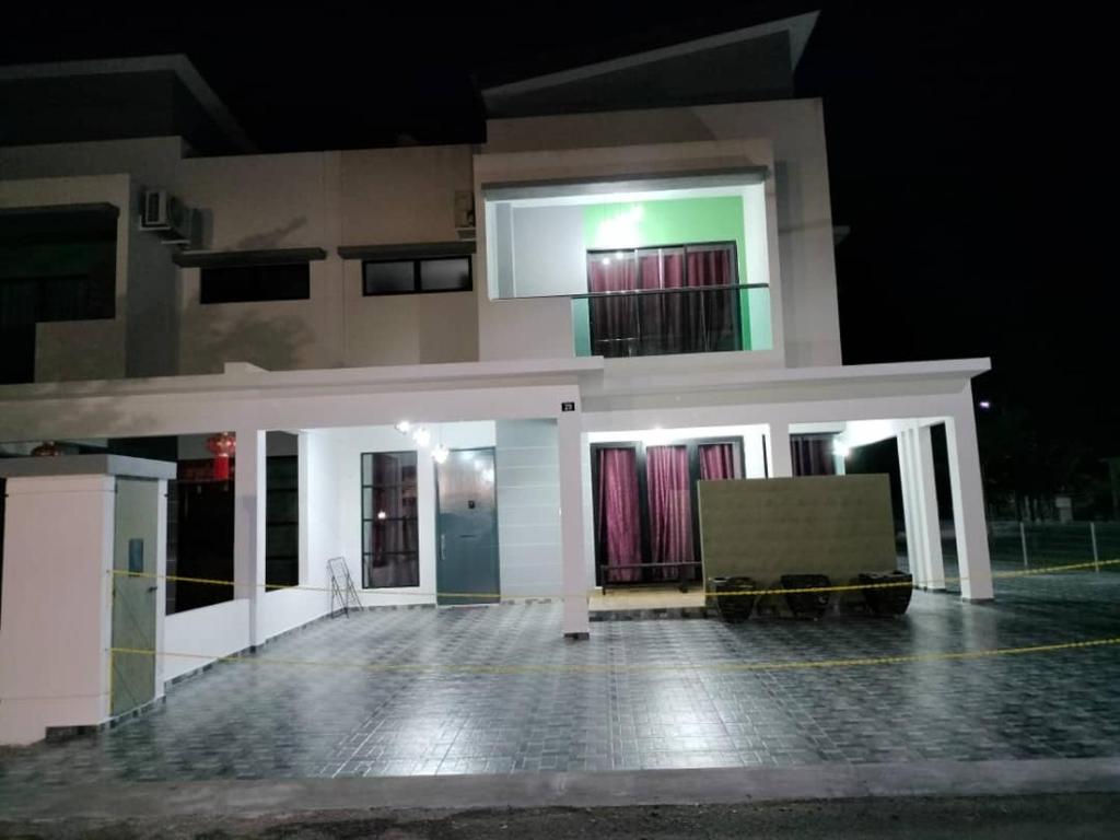 a house at night with its lights on at Pangkor L29, Dream Island Homestay in Kampong Sungai Udang