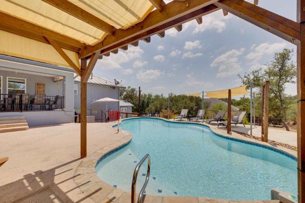 a swimming pool with a pergola next to a house at 1-Story Hill Country Home Near Fiesta with Pool! in San Antonio