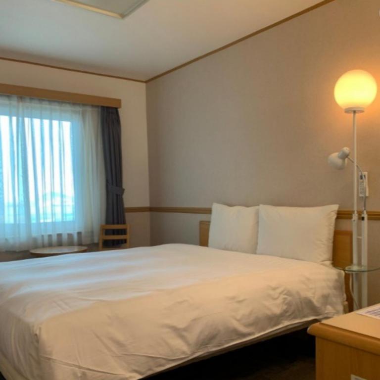 Postel nebo postele na pokoji v ubytování Toyoko Inn Busan Station No.1