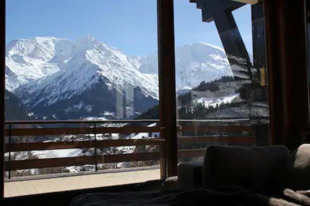 a room with a view of a snow covered mountain at La villa des Tacounets 20 pers in Saint-Gervais-les-Bains