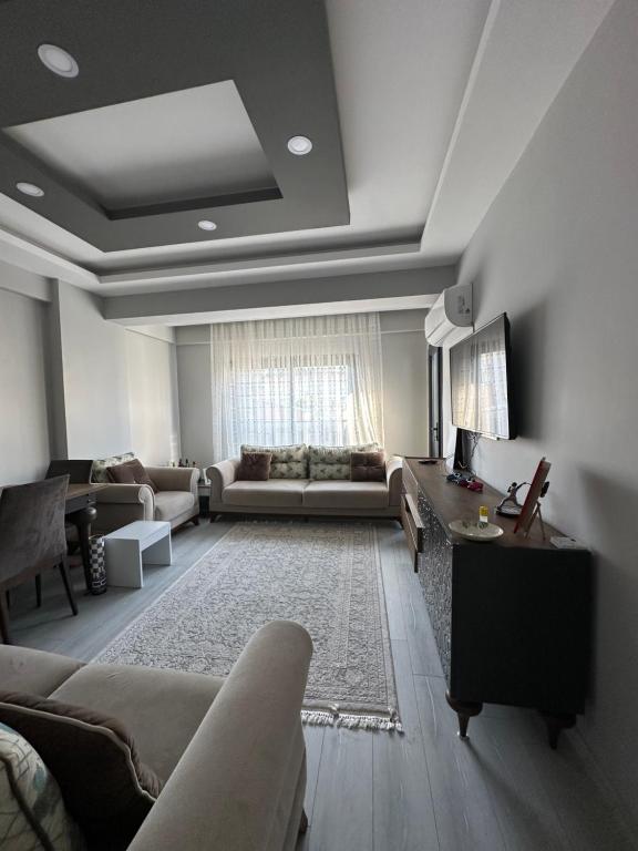 a living room with a couch and a table at Konforlu in Aydın