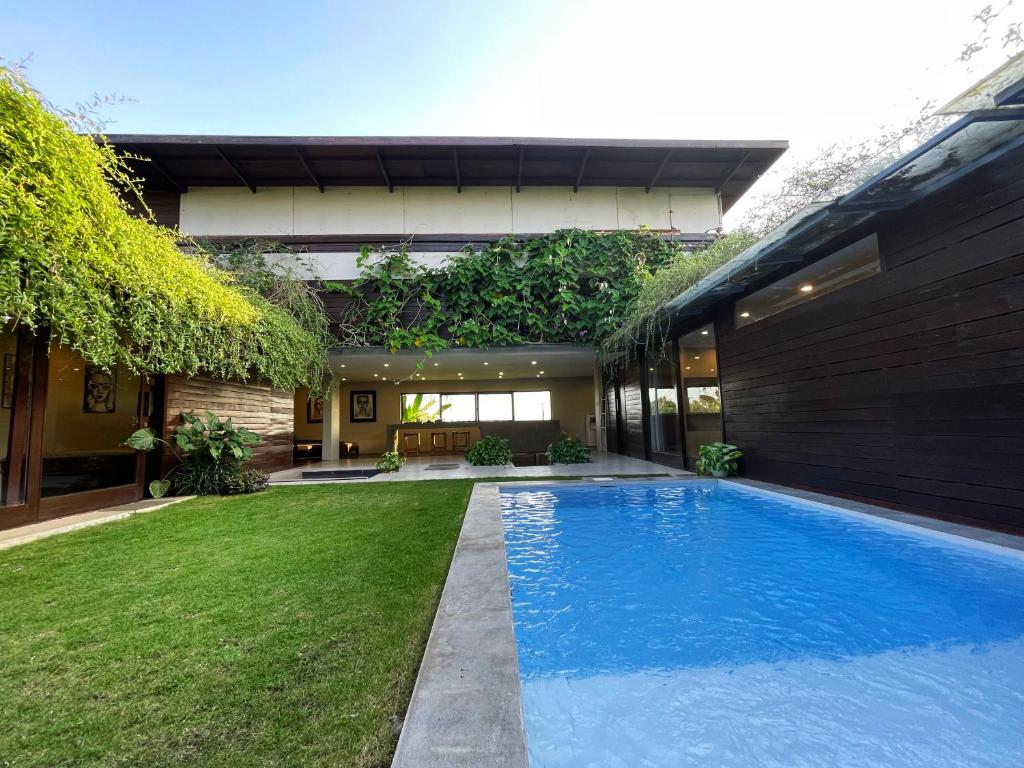 a swimming pool in the backyard of a house at Ocean Villa - Joshua District in Tabanan