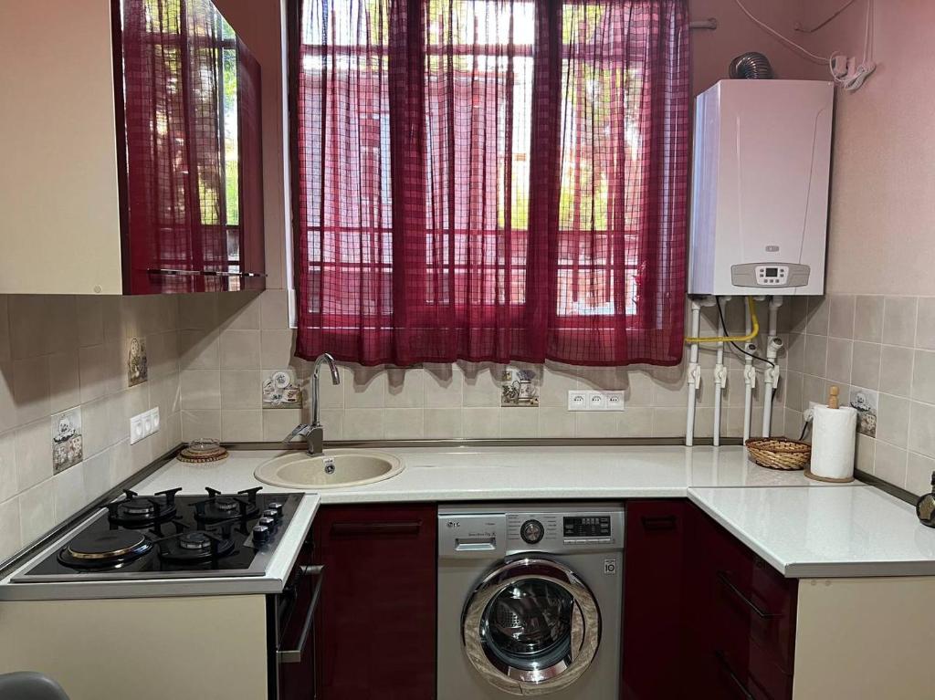 a kitchen with a sink and a washing machine at Appartment in the city center in Gyumri