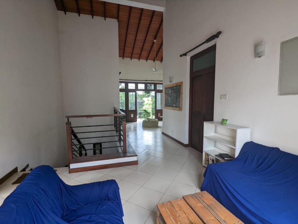 a living room with a blue bed and a hallway at Culture Hub Backpack Hostel in Sri Jayewardenepura Kotte