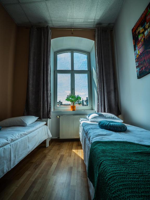Postel nebo postele na pokoji v ubytování Hostel Pod Basztą