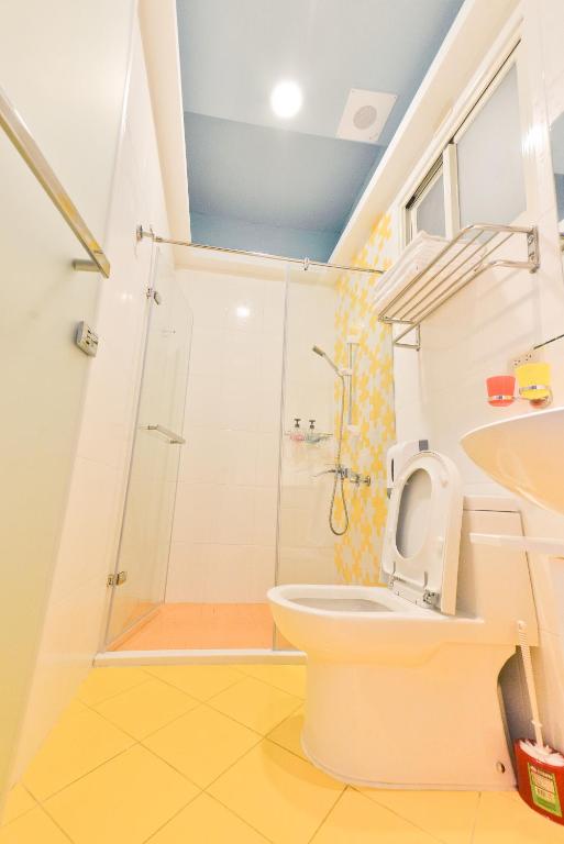 a bathroom with a shower and a toilet and a sink at Minsuku B&amp;B in Taitung City