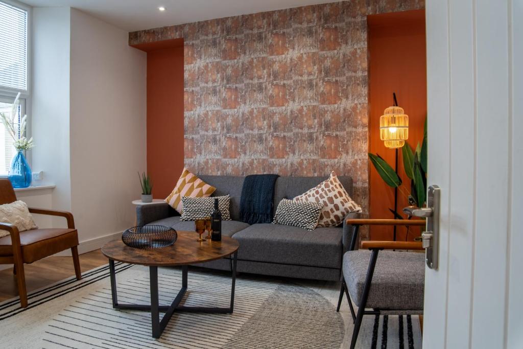 a living room with a couch and a table at City Chic Apartment in Newport