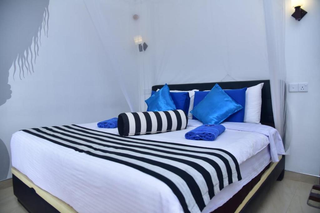 Postel nebo postele na pokoji v ubytování Ella Nimal Nest Inn