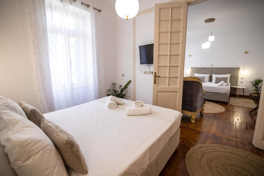 a bedroom with a bed with two towels on it at Apeiron Acropolis Suites in Athens