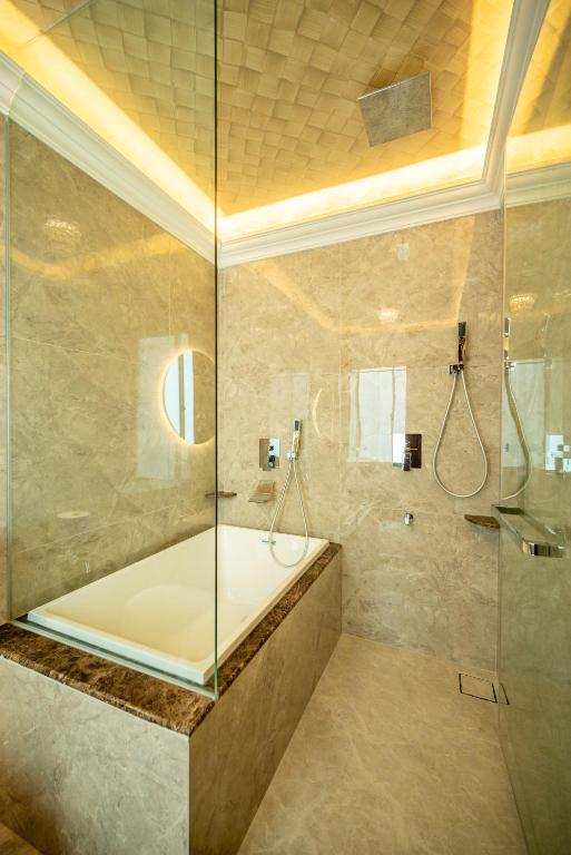 a bathroom with a shower with a glass door at Ritz Residence @ Imago Loft B 7th Floor in Kota Kinabalu