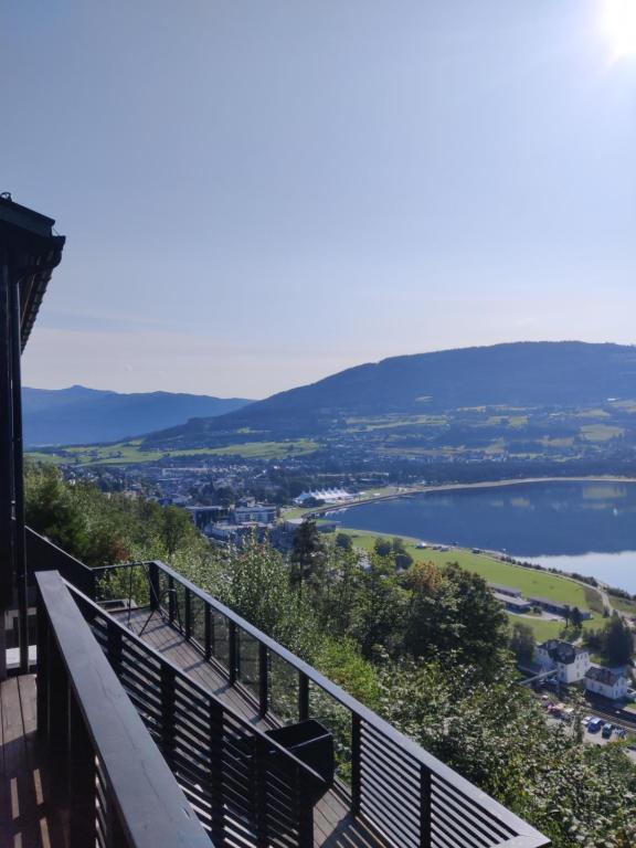 a balcony of a building with a view of a lake at Modern family home in Voss in Vossevangen