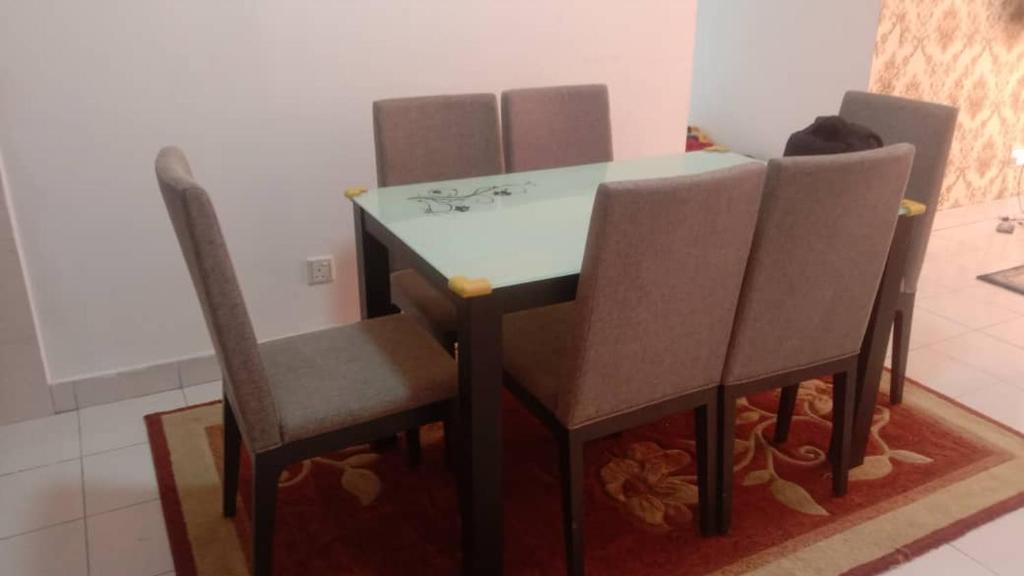 a dining room table and chairs in a room at PR1MA Presint 11 Putrajaya in Putrajaya