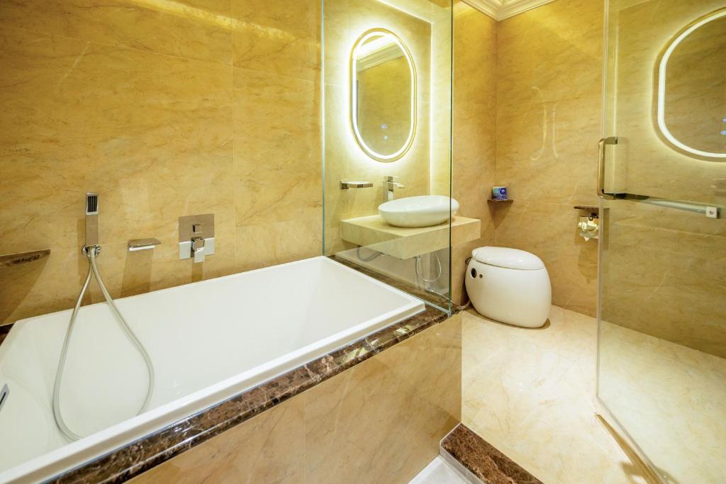 a bathroom with a shower and a toilet and a sink at Ritz Residence @ Imago Loft B 7th Floor in Kota Kinabalu