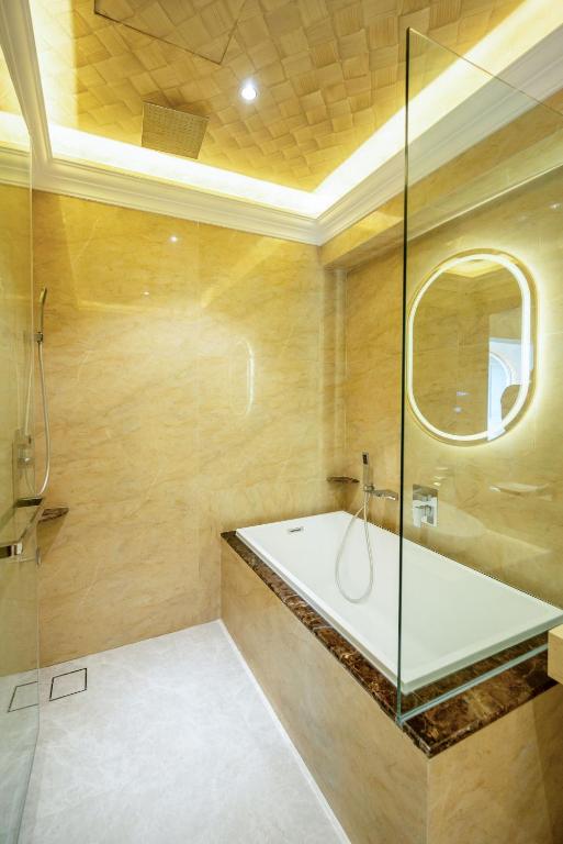 a bathroom with a tub and a glass shower at Ritz Residence @ Imago Loft B 7th Floor in Kota Kinabalu