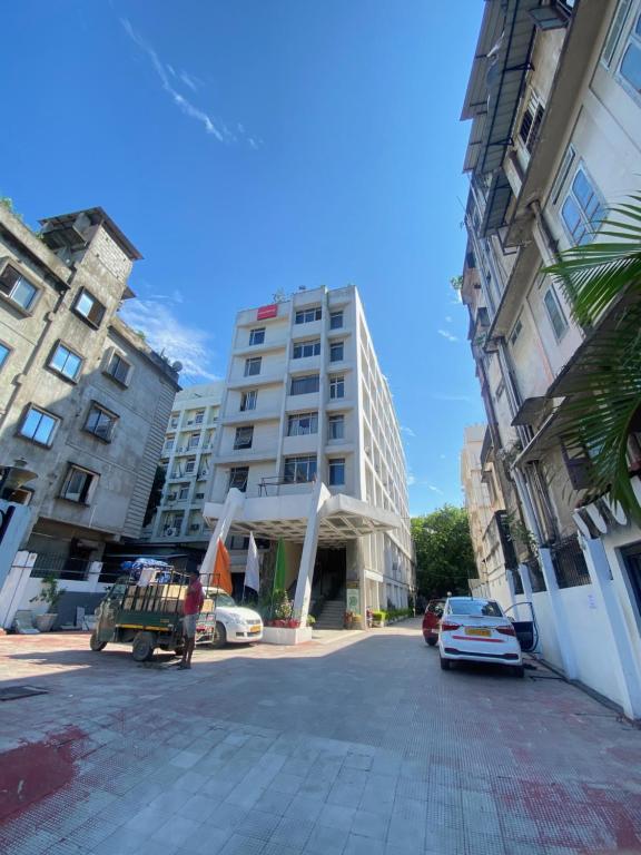 a street in a city with buildings and cars at Hotel Rituraj in Guwahati