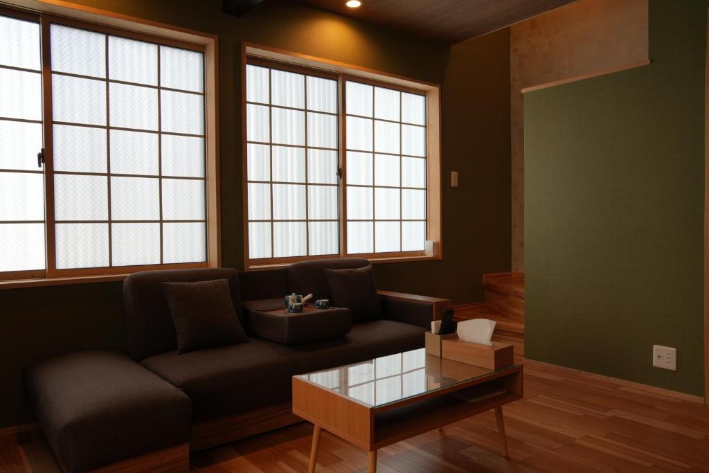 a living room with a couch and a table at Kyoto-cocoro house in Kyoto