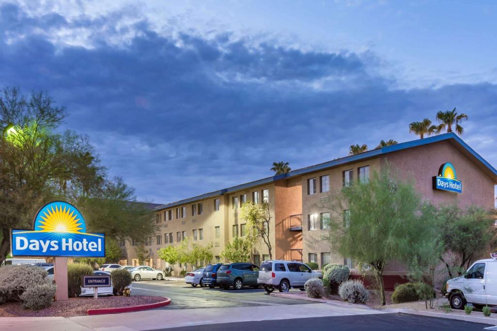 a view of a days hotel with cars parked in a parking lot at Days Hotel by Wyndham Mesa Near Phoenix in Mesa