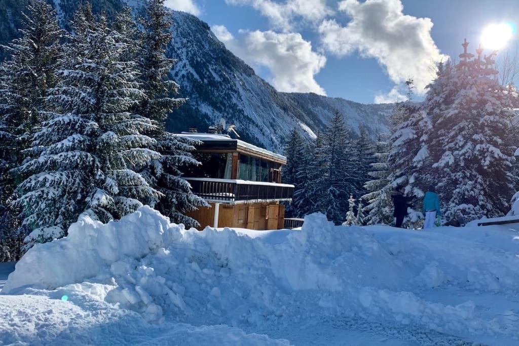 a pile of snow in front of a building at Chalet Robaumont - Grand chalet familial proche du centre et des pistes in Courchevel