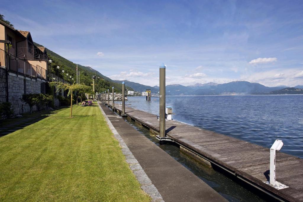 un muelle en el agua junto a un cuerpo de agua en Yachting Residence, en Ghiffa