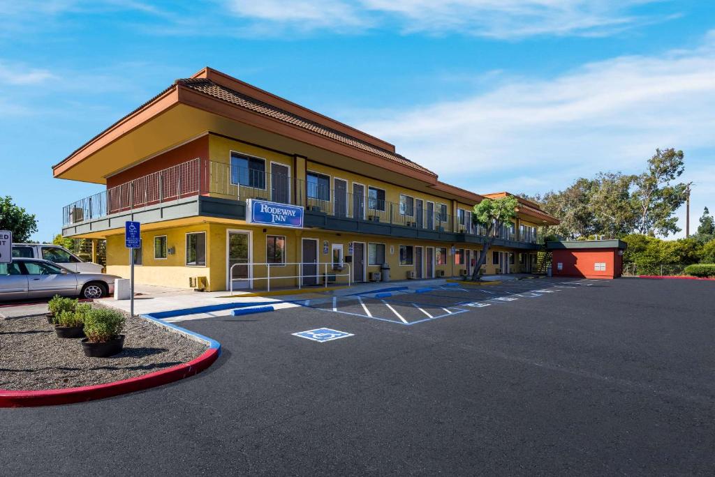 a building with a parking lot in front of it at Rodeway Inn Livermore in Livermore
