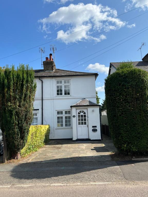 a white house with a white garage at The Windmill in Busheyheath