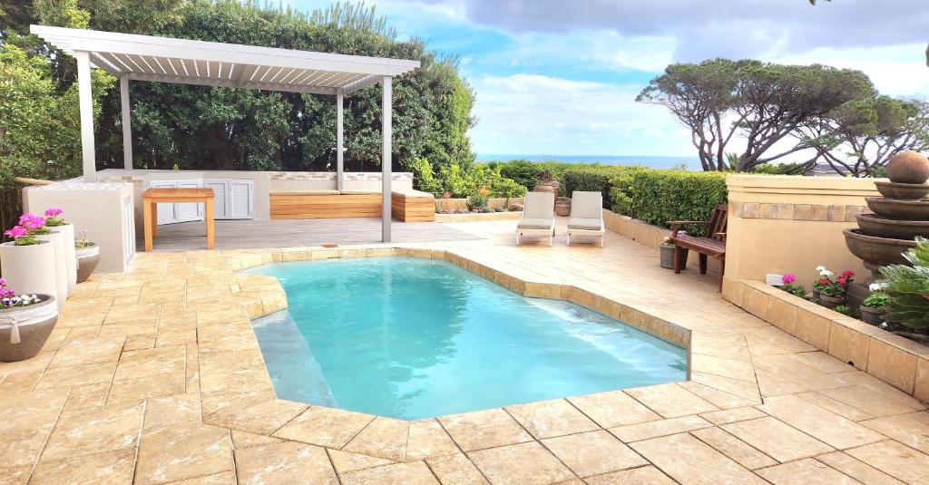 a swimming pool in the middle of a patio at HORIZON BAY - Camps Bay in Cape Town