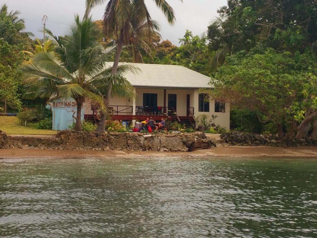 a house on the shore of a body of water at Santo Seaside Villas in Luganville