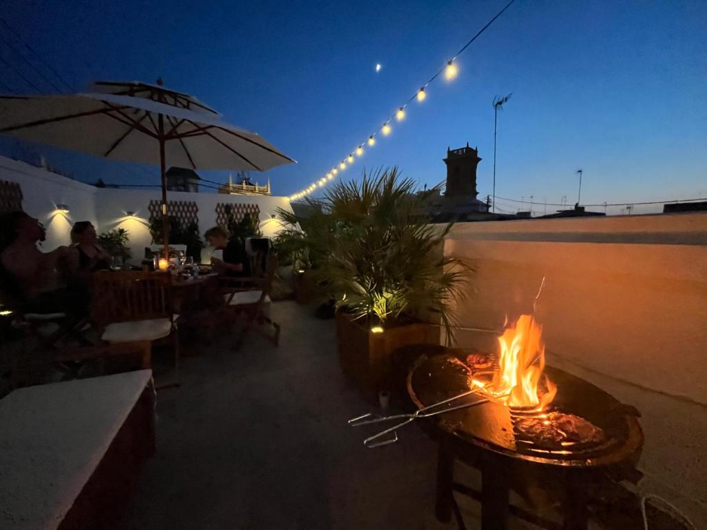 a fire pit on the patio of a restaurant at night at Luxury Apartment Valencia Center in Valencia