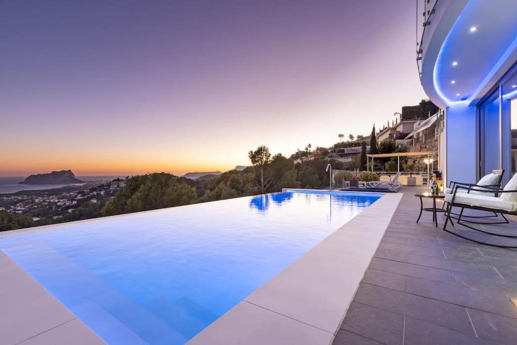 a large swimming pool on the side of a house at Moonlit BB Spa Art boutique Cab in Teulada