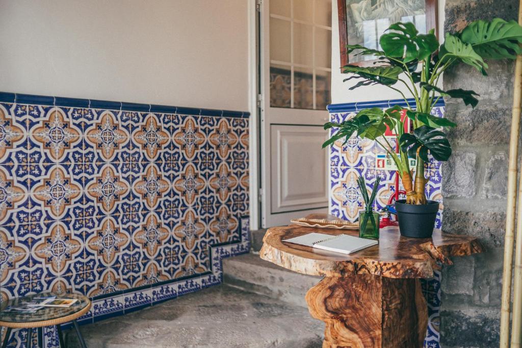 a room with blue and white tiles and a table with plants at Casa do Riacho in Nordeste