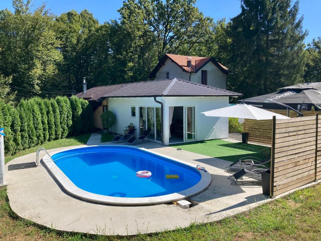 a swimming pool in a yard next to a house at Vikendica Konstantin in Laktaši