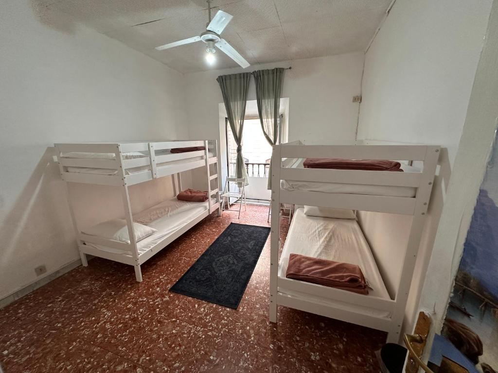 a room with two bunk beds and a ceiling at Baraka Guest House in Rome