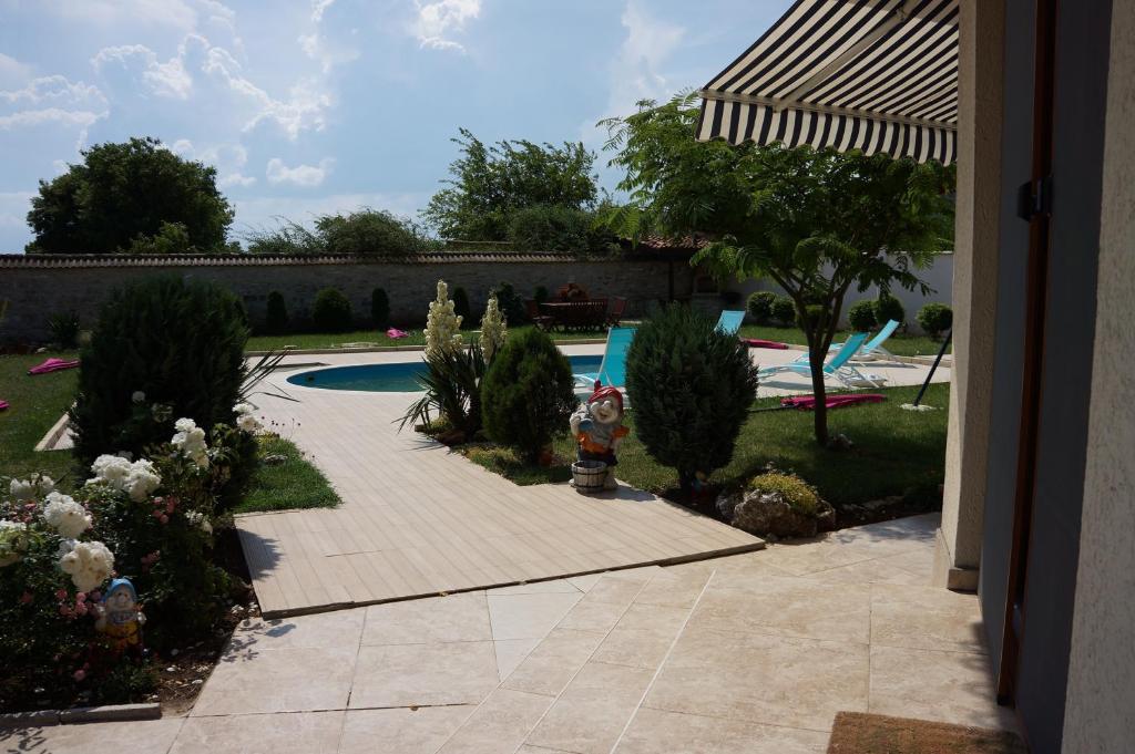 a backyard with a swimming pool with a fire hydrant at Guest House Golden Flake 4km from Bolata beach in Bŭlgarevo