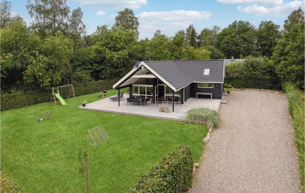 a house with a large yard with a playground at 3 Bedroom Amazing Home In Silkeborg in Silkeborg